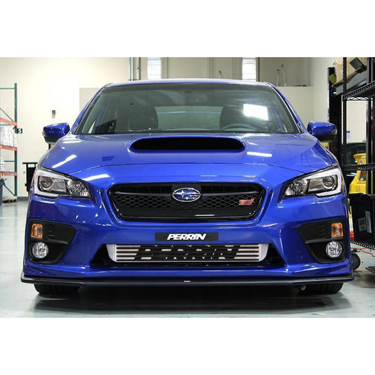 Black core and beam Perrin front mount intercooler for 2015-2021 Subaru WRX and STI, shown installed with visible fins and mounting brackets.