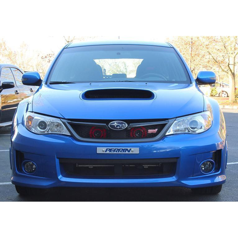 PERRIN Hella horn bracket for 2008-2014 Subaru WRX STI, mounted on engine bay, black metal bracket with attached horns.