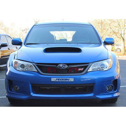 PERRIN Hella horn bracket for 2008-2014 Subaru WRX STI, mounted on engine bay, black metal bracket with attached horns.