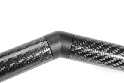 Perrin universal carbon fiber strut brace with billet feet, designed for improved chassis stiffness and performance in JDM vehicles.