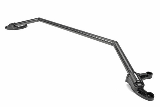 JDMuscle Perrin carbon fiber strut brace with billet feet mounted in a car engine bay for enhanced suspension support