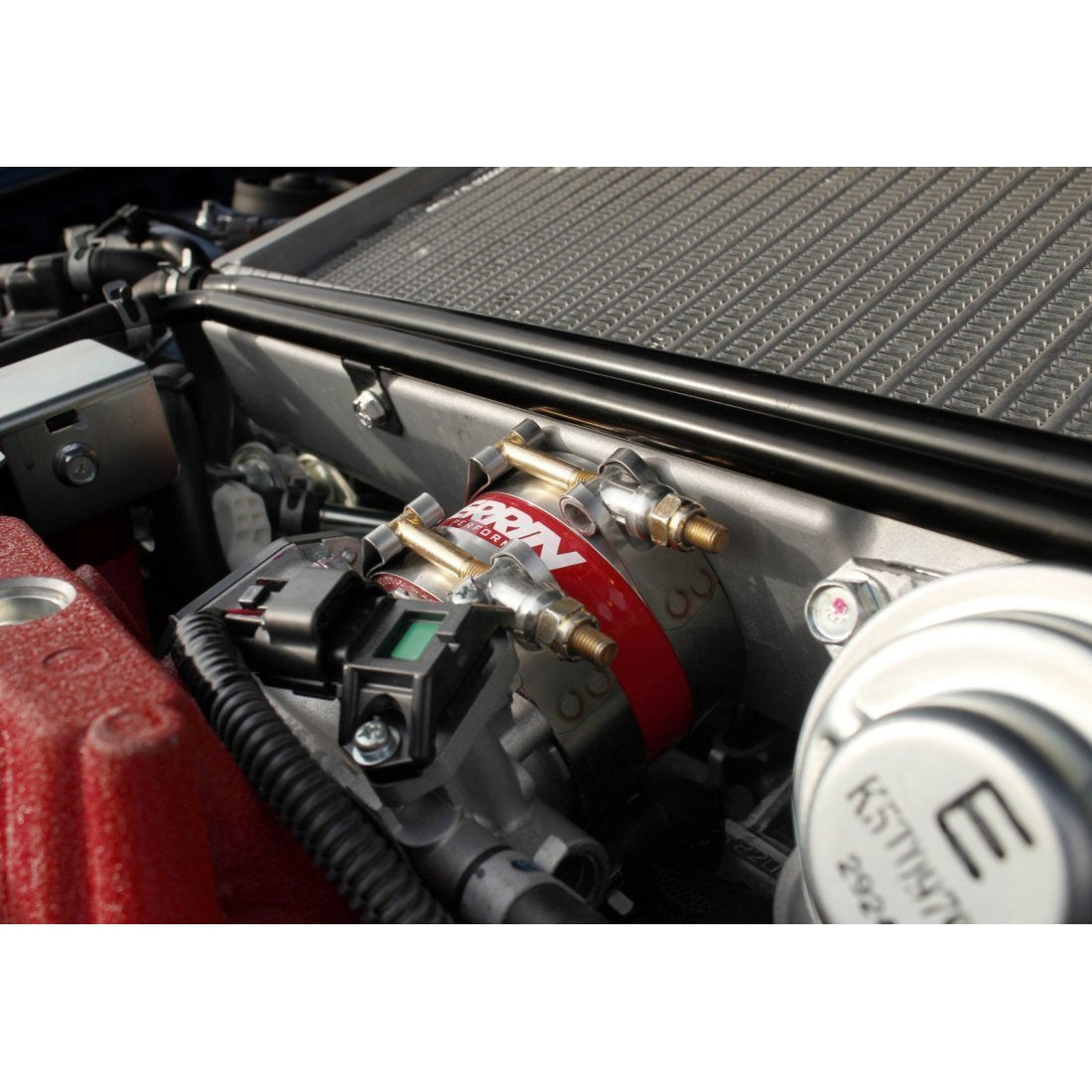 Black PERRIN throttle body intercooler hose kit for Subaru WRX 2002-2007 and STI 2004-2021, displayed on top of engine.