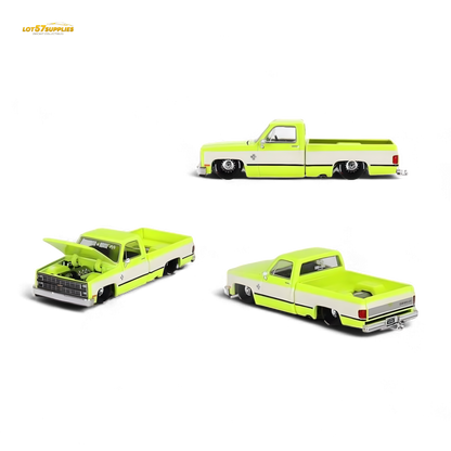 Mini GT x Kaido House Chevrolet Silverado FLO Yellow diecast model in 1:64 scale, yellow Chevrolet pickup truck with detailed features.