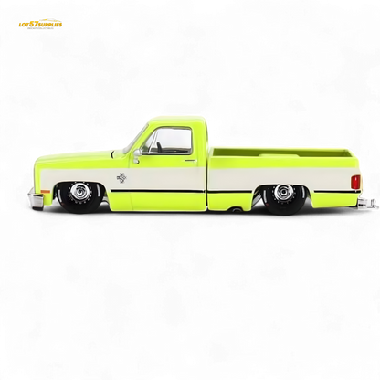 Mini GT x Kaido House Chevrolet Silverado FLO YELLOW diecast model in 1:64 scale, bright yellow Chevrolet pickup truck.