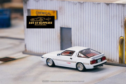 White Mitsubishi Starion diecast model in 1:64 scale by Tarmac Works, detailed miniature car on display