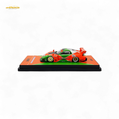 Orange and green Inno64 Mazda RX-7 LBWK diecast model in 1:64 scale with detailed exterior features.