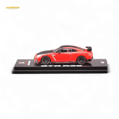 Red Inno64 Nissan GT-R R35 Nismo diecast model car, detailed miniature vehicle with distinctive Nissan design and Nismo branding.