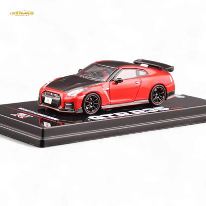 Red Inno64 Nissan GT-R R35 Nismo diecast model car in 1:64 scale, detailed miniature vehicle on white background.