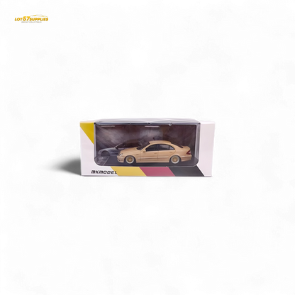 Mercedes-Benz E63 AMG W211 diecast model in desert yellow, 1:64 scale, showcasing detailed exterior and design features.