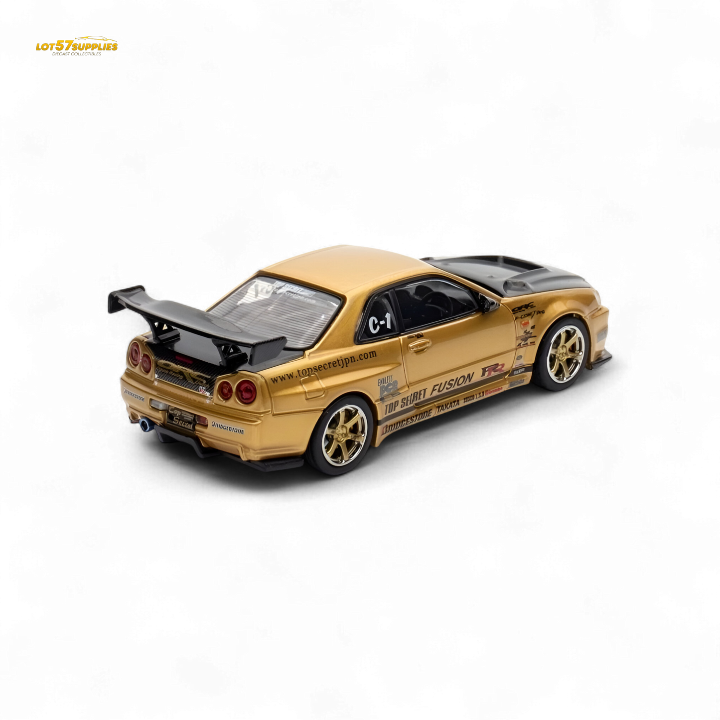 Gold Inno64 Top Secret R34 GT-R diecast Nissan model in 1:64 scale, detailed miniature car on display.
