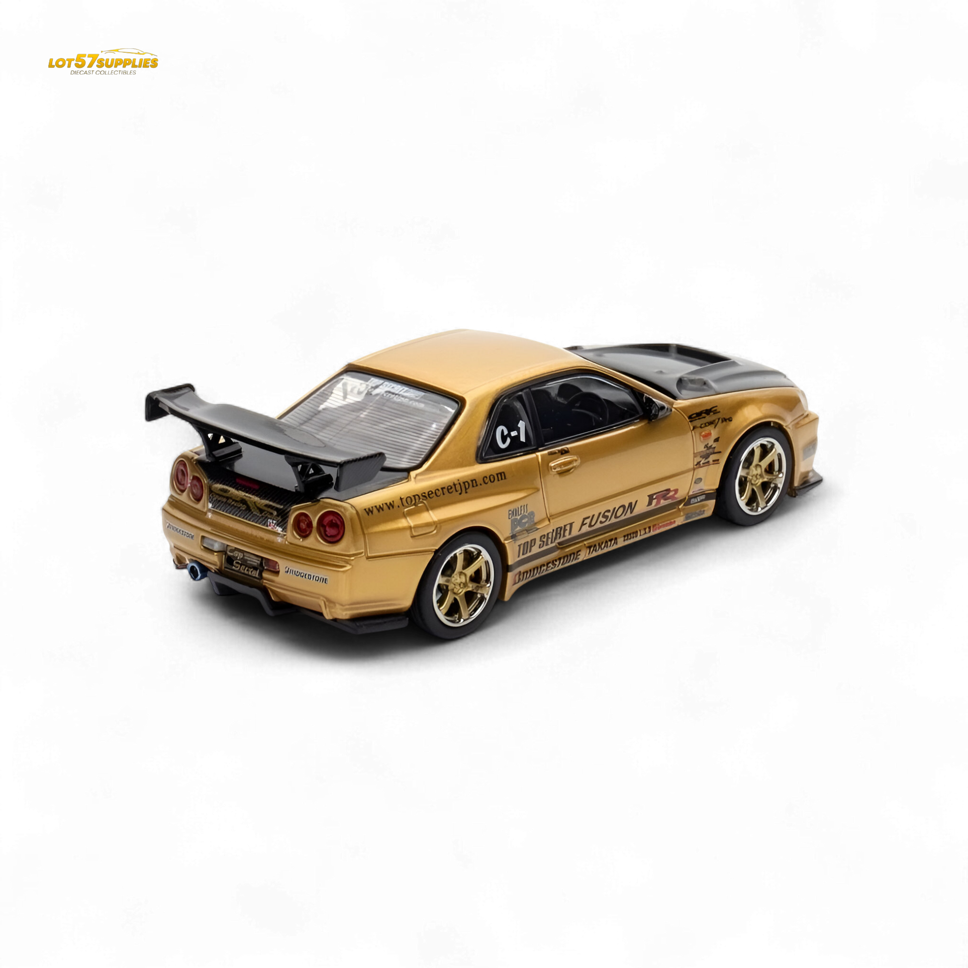 Gold Inno64 Top Secret R34 GT-R diecast Nissan model in 1:64 scale, detailed miniature car on display.