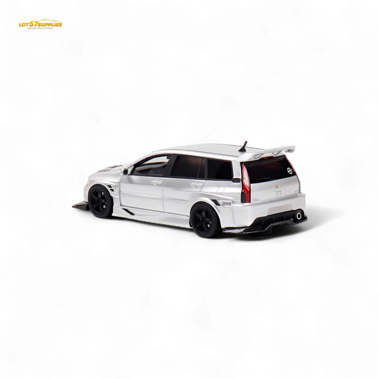 Glossy silver Mitsubishi Lancer EVO 9 Wagon diecast model in 1:64 scale, featuring detailed exterior and realistic design.