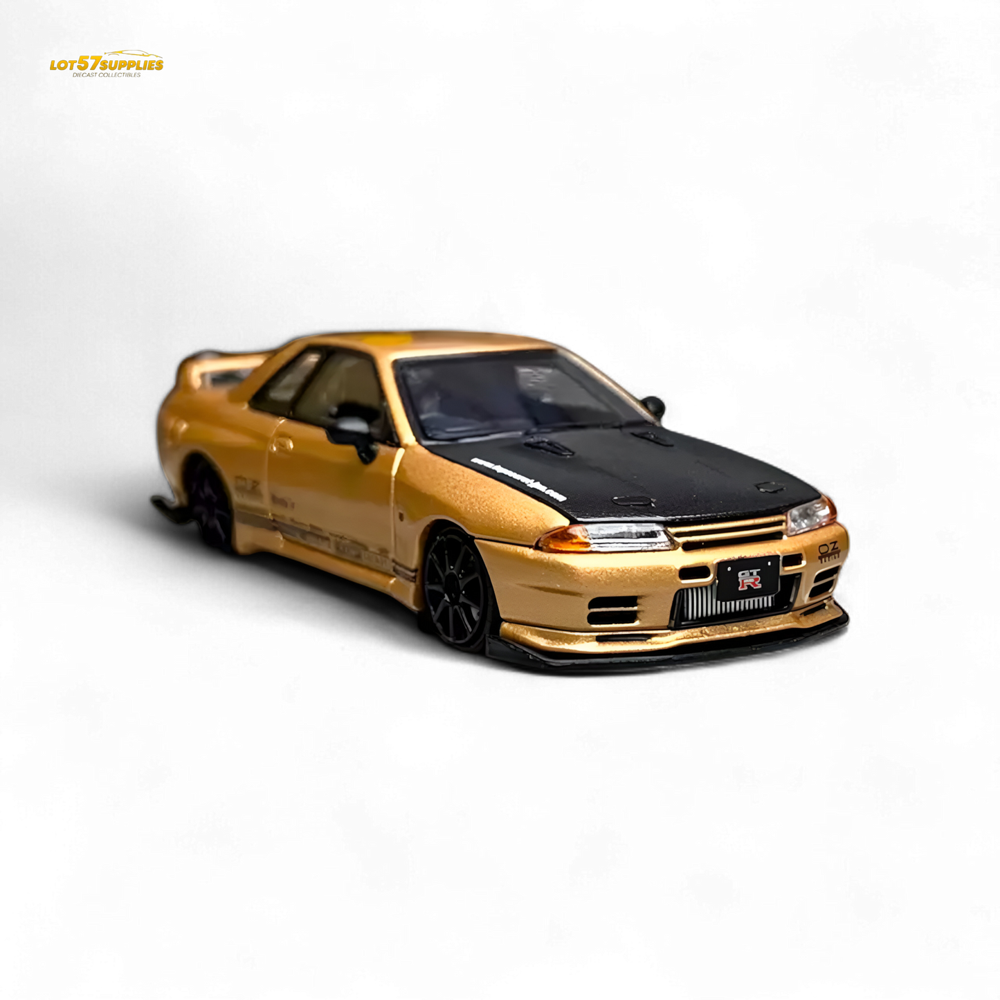 Gold 1:64 scale Focal Horizon Nissan Skyline GT-R R32 diecast model, detailed Nissan car with Top Secret branding.