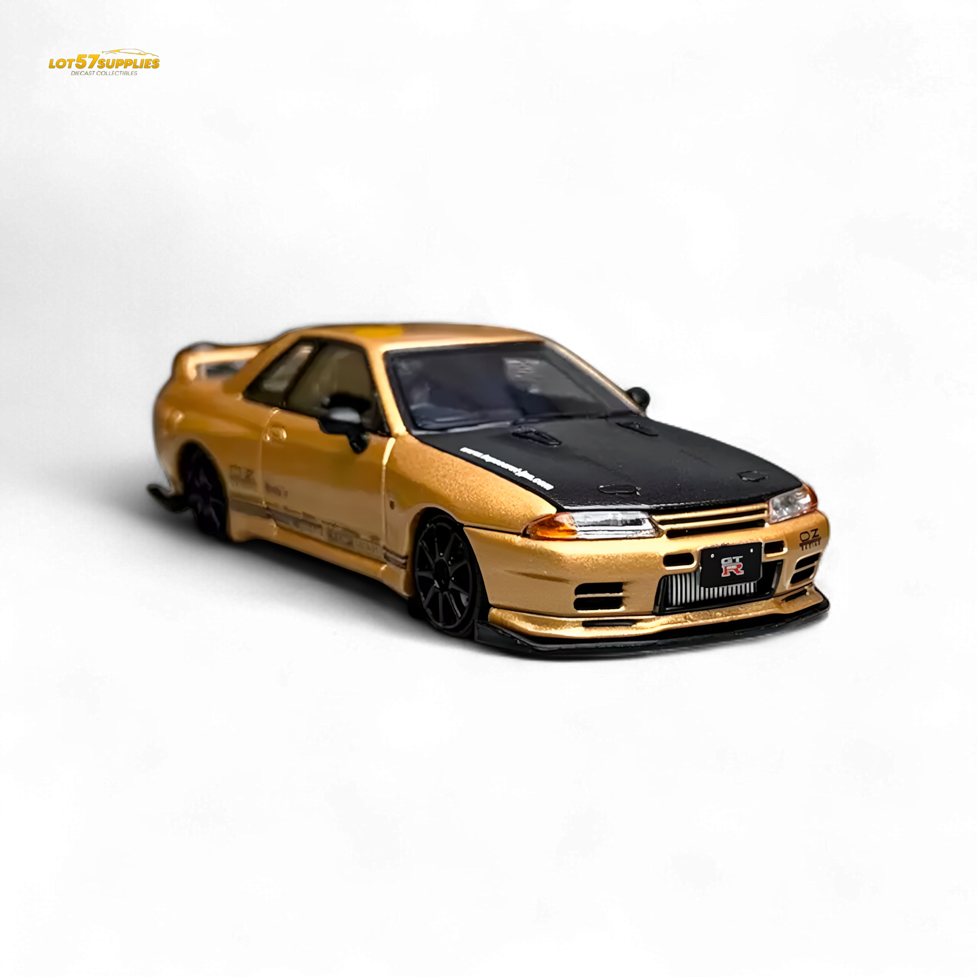 Gold 1:64 scale Focal Horizon Nissan Skyline GT-R R32 diecast model, detailed Nissan car with Top Secret branding.