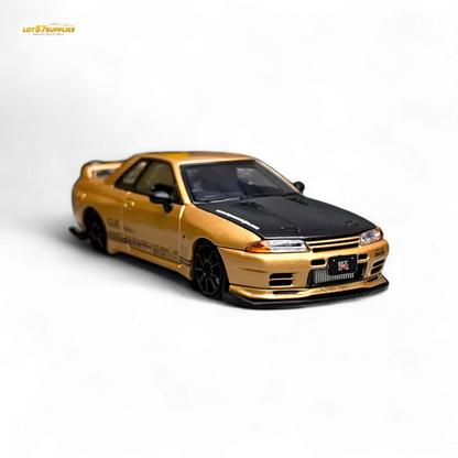 Gold 1:64 scale Focal Horizon Nissan Skyline GT-R R32 diecast model, detailed Nissan car with Top Secret branding.