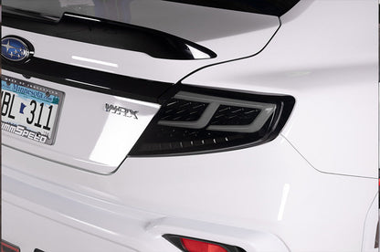OLM Spec-AR LED taillights with smoke lens, black base, and white bar installed on a 2022+ Subaru WRX.