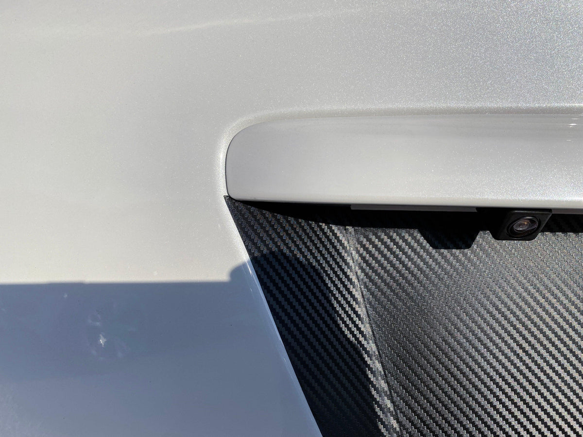 Black 3D carbon fiber license plate panel overlay for 2015-2020 Subaru WRX and STI, exterior body accessory by StickerFab.