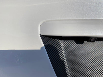Black 3D carbon fiber license plate panel overlay for 2015-2020 Subaru WRX and STI, exterior body accessory by StickerFab.