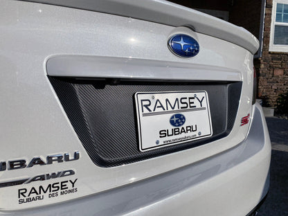 StickerFab 3D carbon license plate panel overlays on a 2015-2020 Subaru WRX STI, showcasing black-out exterior body accessories.
