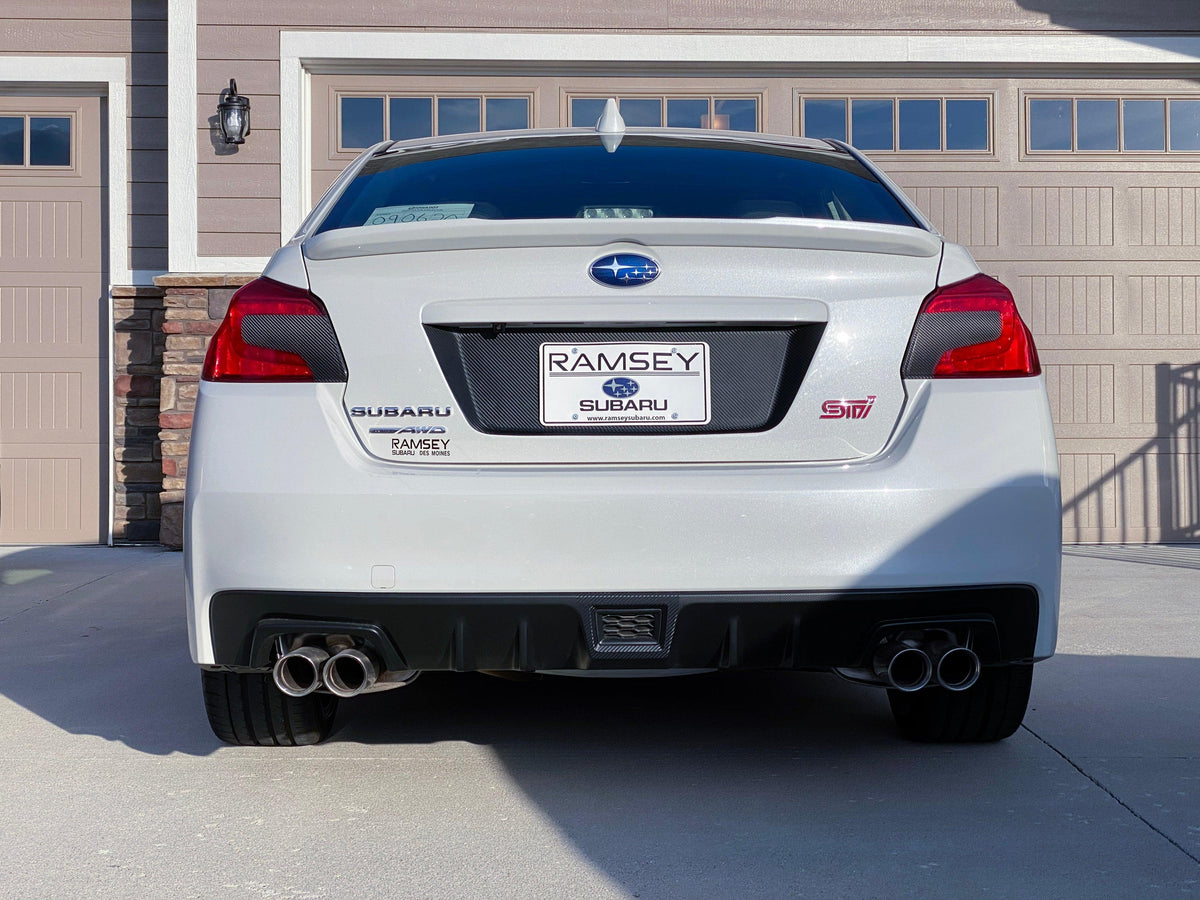 Black 3D carbon fiber license plate panel overlays for 2015-2020 Subaru WRX/STI from StickerFab, designed for exterior body enhancement.