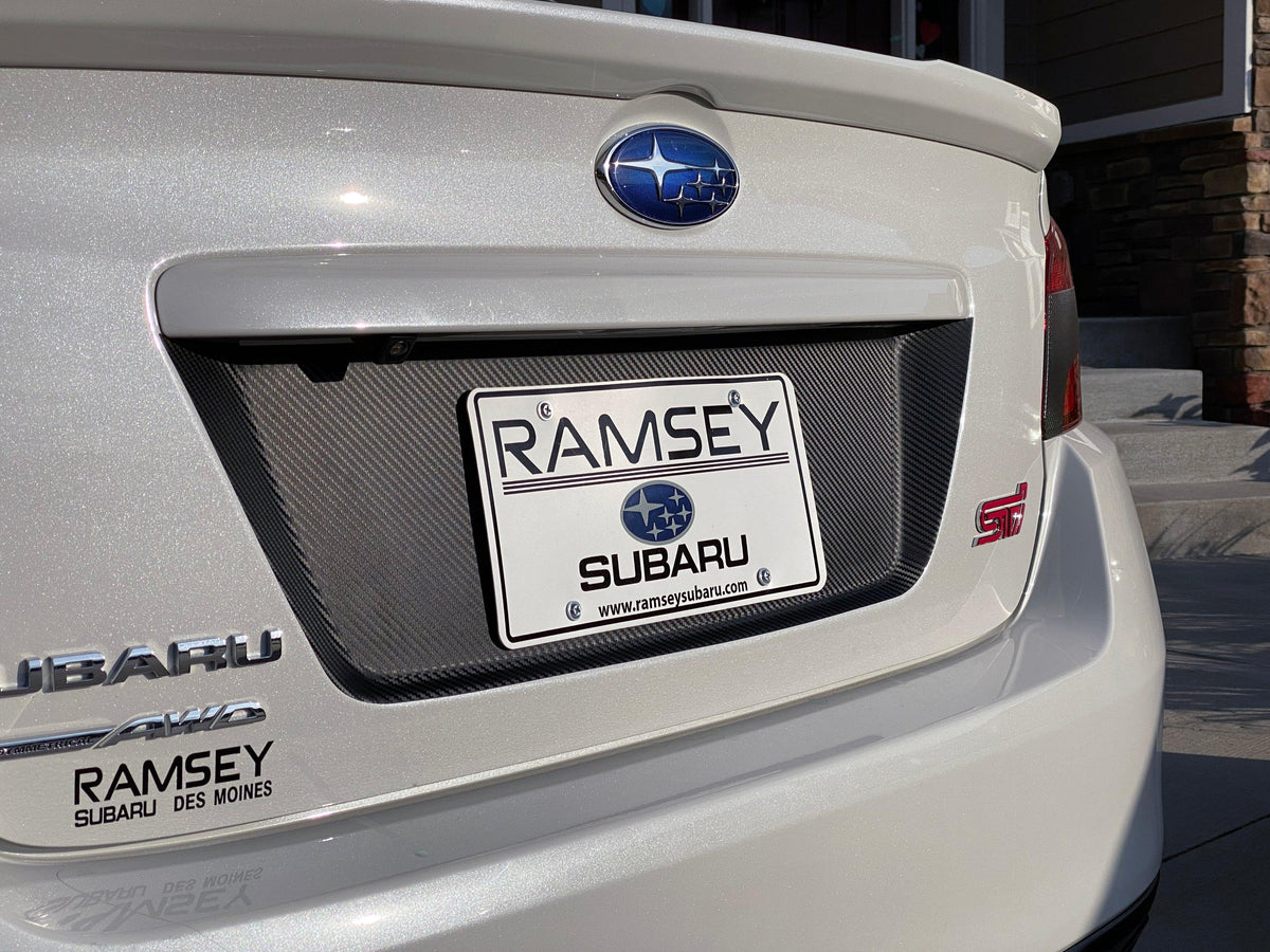Black 3D carbon fiber license plate panel overlays for 2015-2020 Subaru WRX and STI, exterior body accessories by StickerFab.