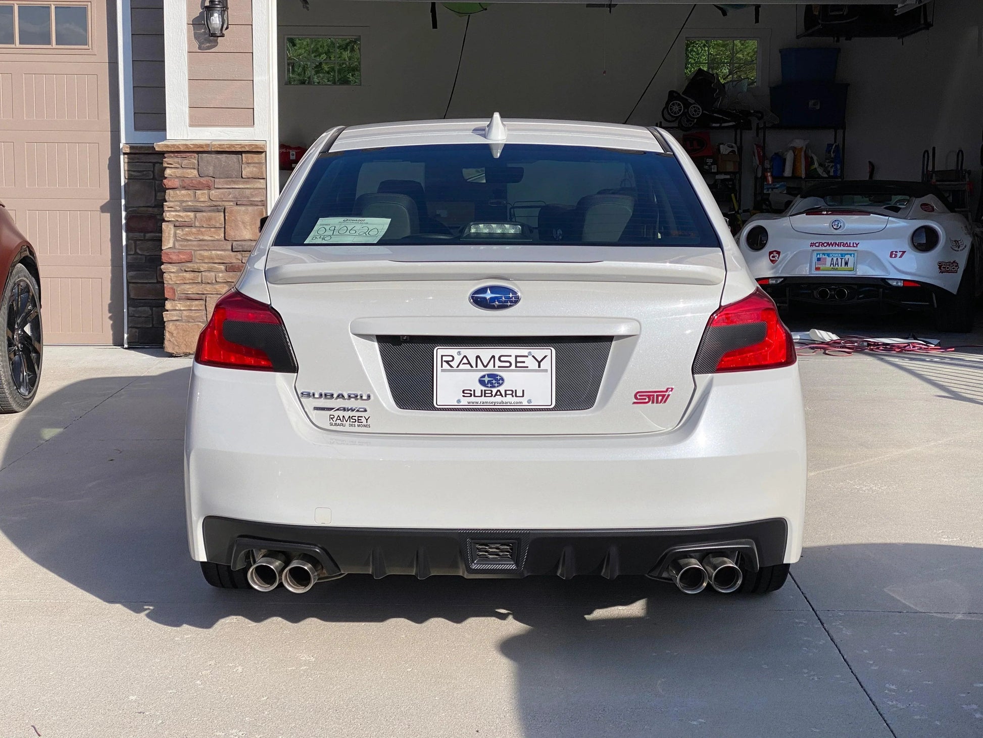 Black Subaru WRX STI V2 License Plate Panel Blackout Overlay by StickerFab on exterior body of 2015-2020 Subaru WRX STI.