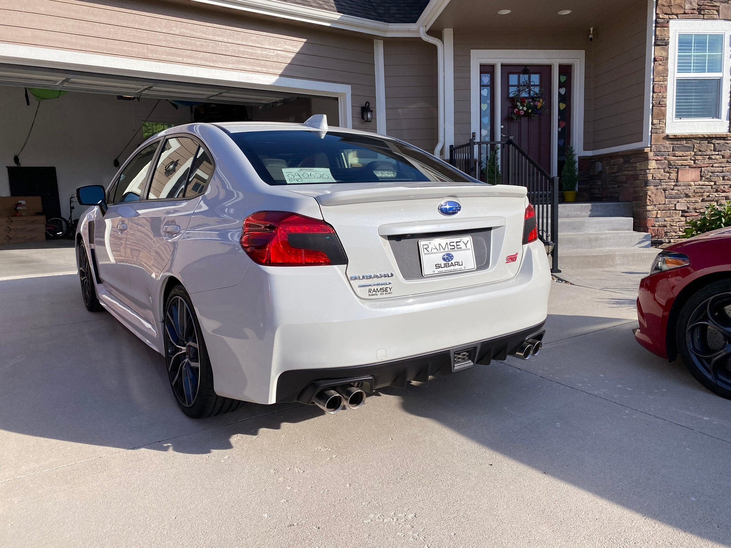 Black out V2 license plate panel overlay for 2015-2020 Subaru WRX and STI, exterior body accessory by StickerFab.