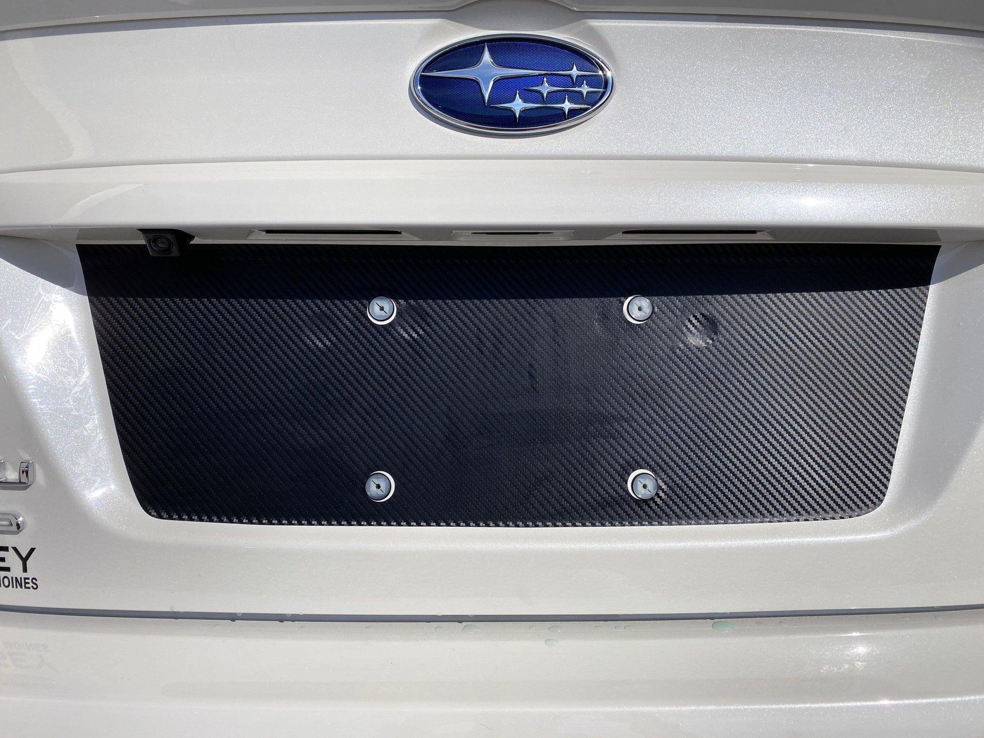 Black out overlay for license plate panel on 2015-2020 Subaru WRX STI, exterior body accessory by StickerFab.