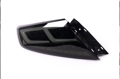 OLM Spec-AR LED taillights for 2022+ Subaru WRX, smoke lens with black base and white bar, designed for stylish vehicle lighting.