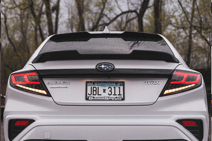 OLM Spec-AR LED taillights with clear lens, black base, and red bar for 2022+ Subaru WRX, showing the tail light design.